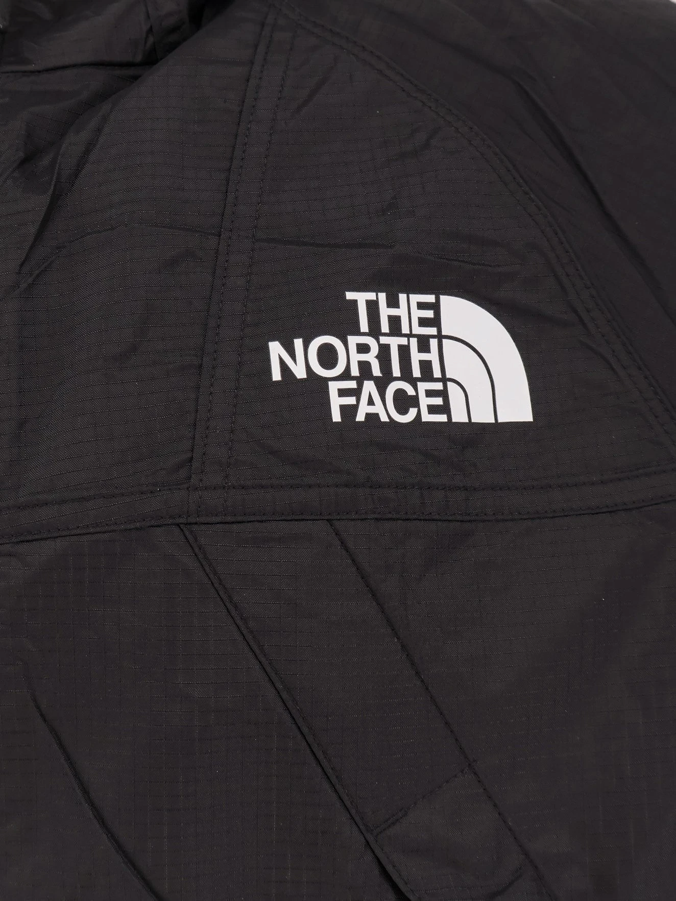 Nylon jacket with logo on the front and on the back.webp