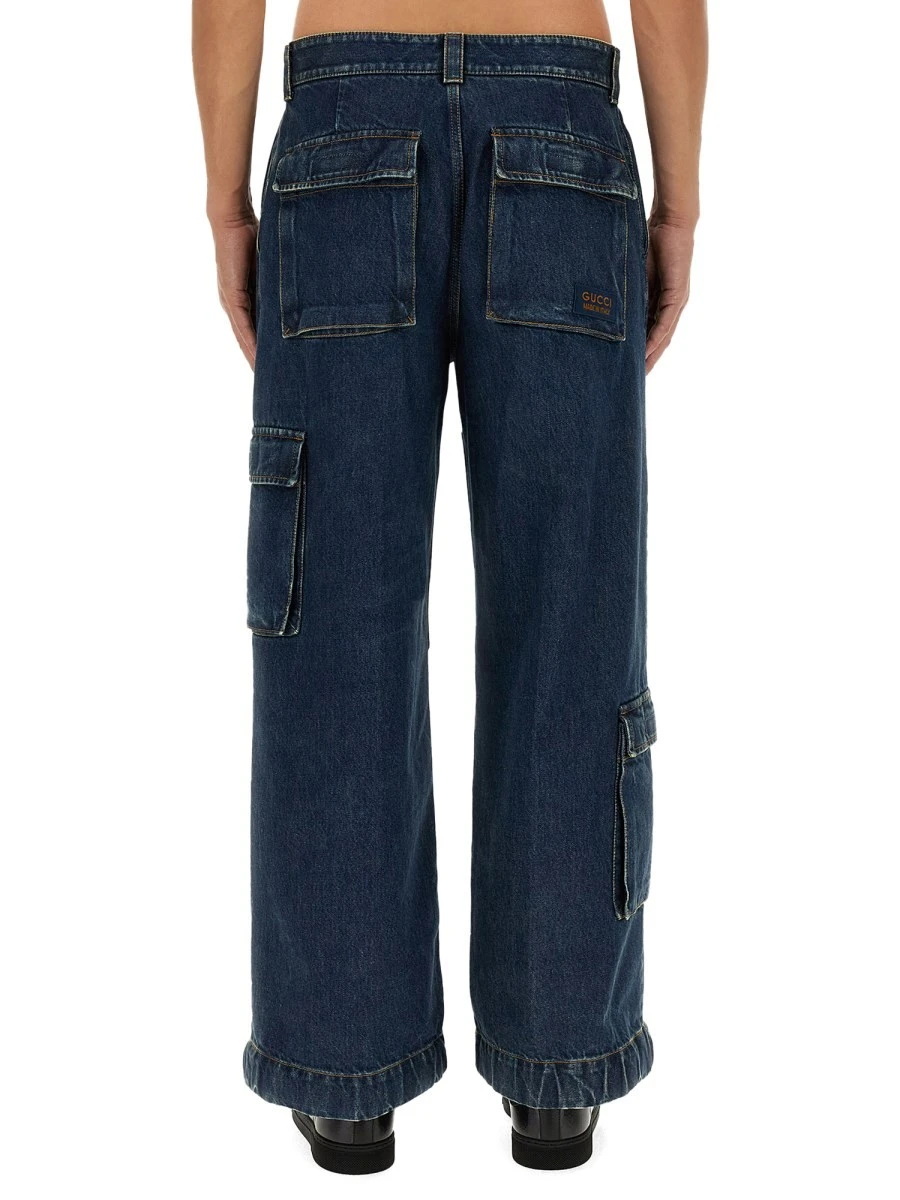 DENIM PANTS WITH GUCCI LABEL.webp