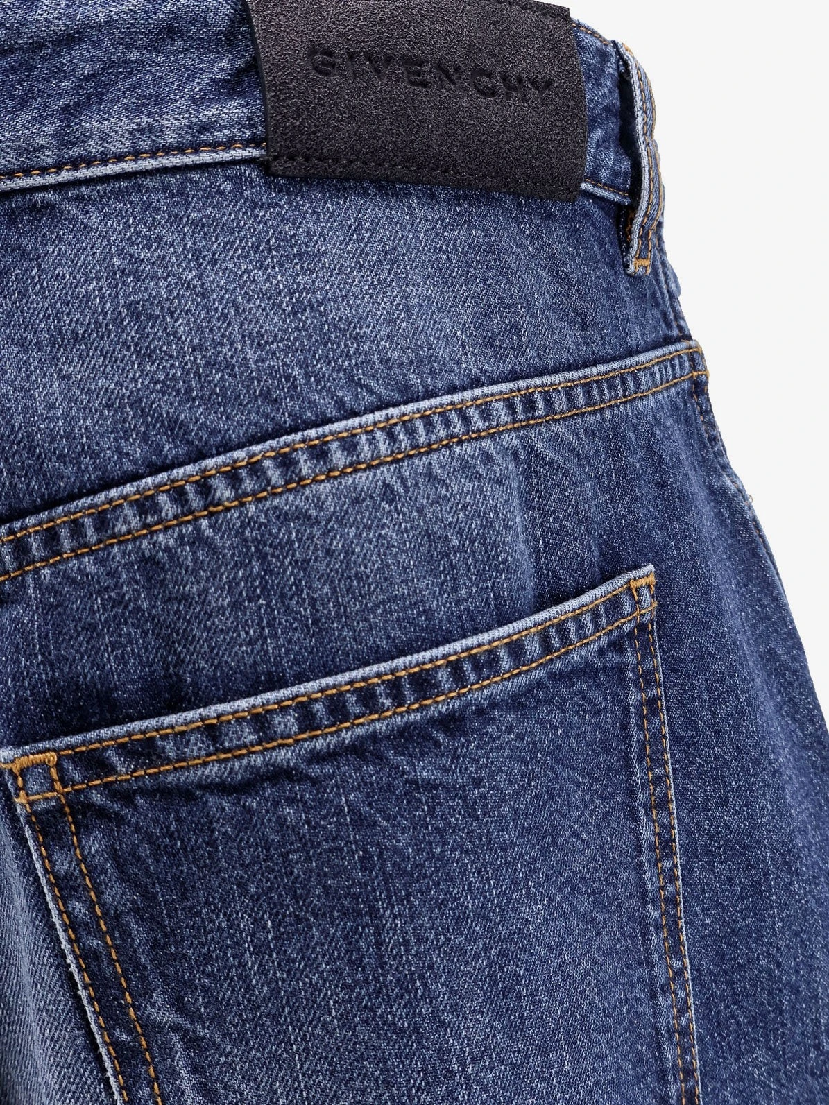 Twisted stone-washed denim jeans.webp