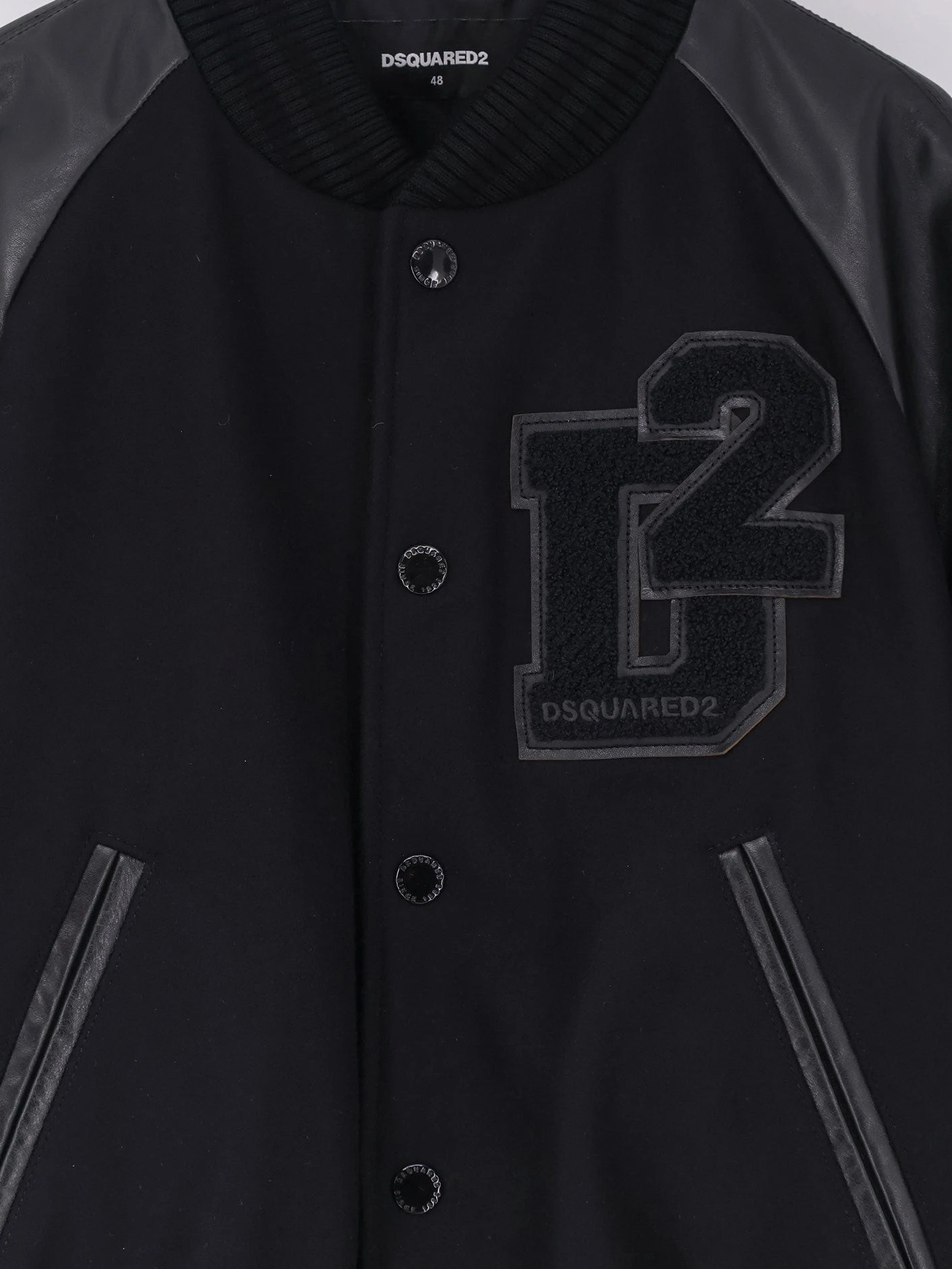 Wool jacket with leather sleeves.webp