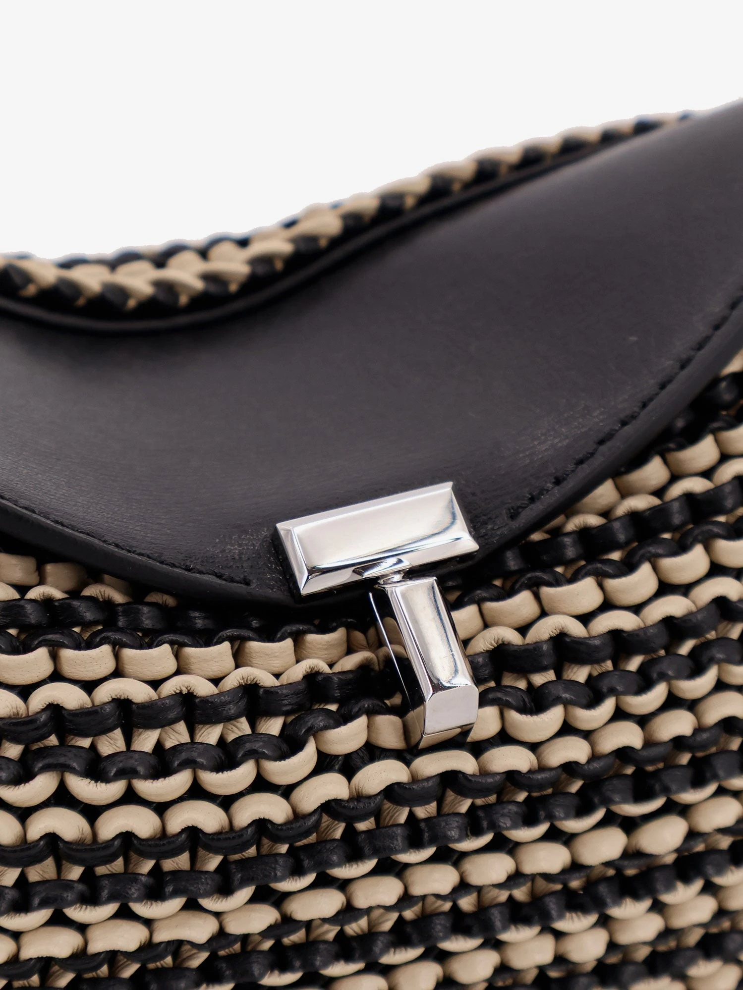 Mini T-lock clutch in leather with woven pattern.webp