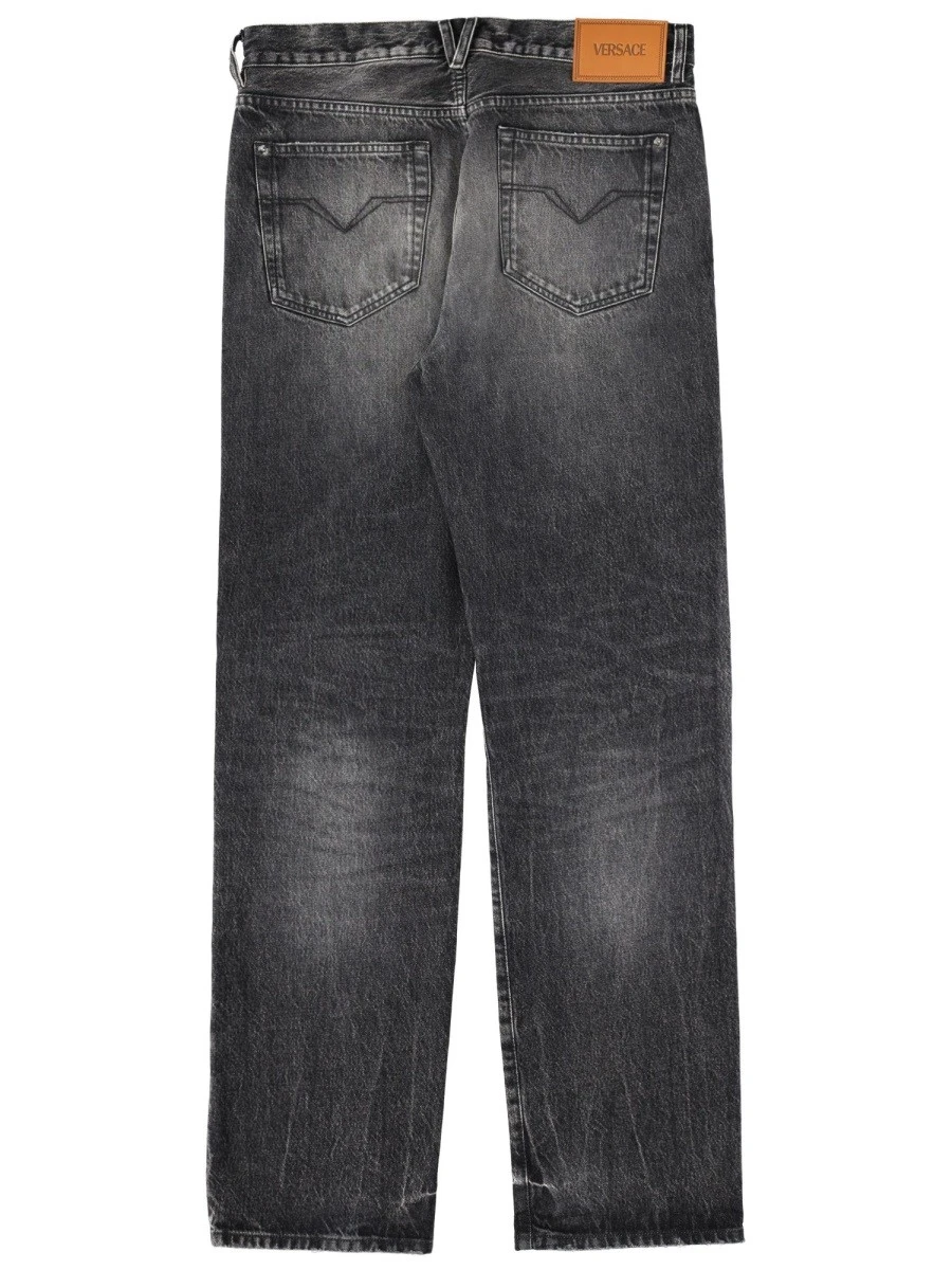 JEANS WITH "MEDUSA" DETAIL.webp