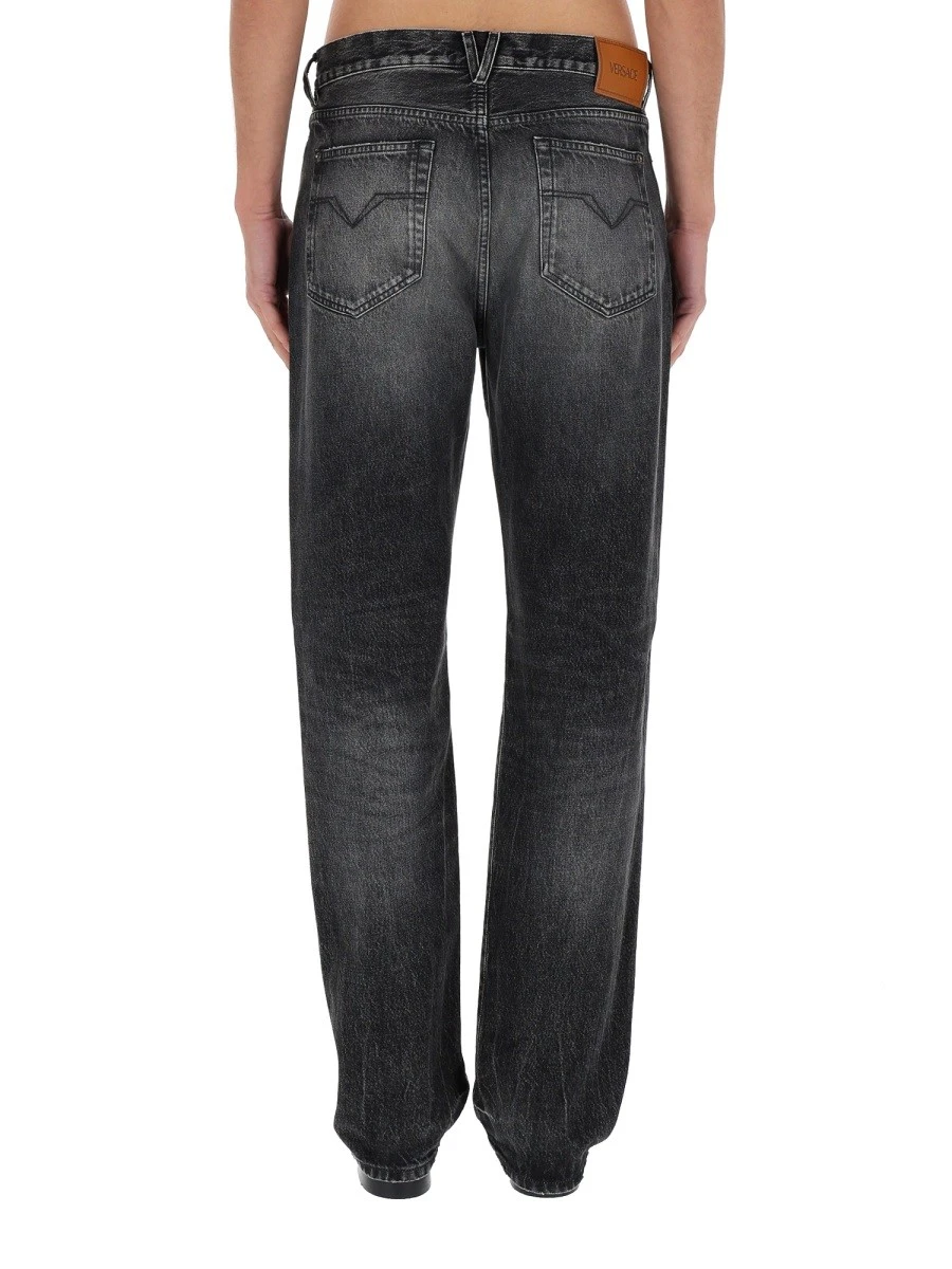 JEANS WITH "MEDUSA" DETAIL.webp