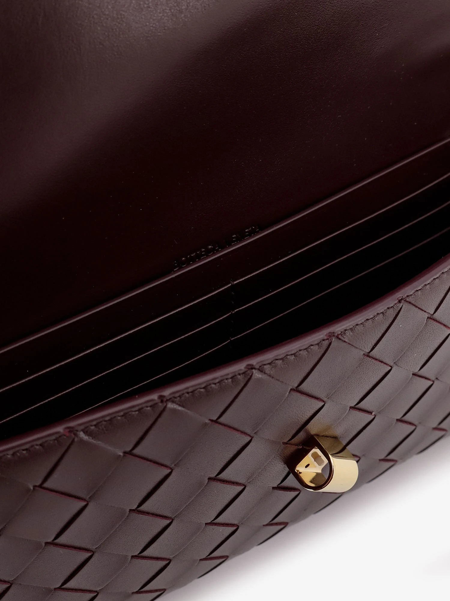 Andiamo leather clutch with woven pattern.webp