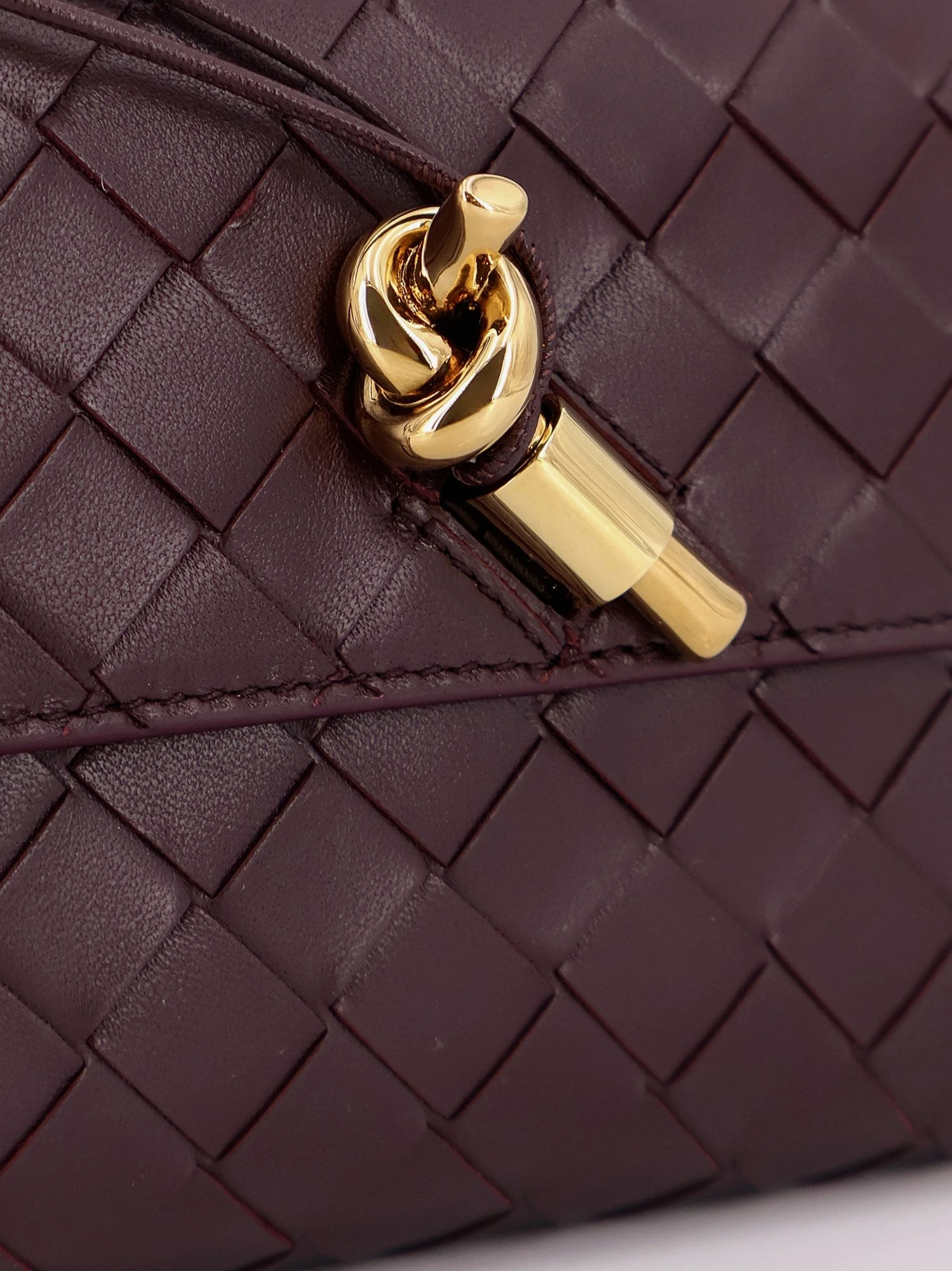 Andiamo leather clutch with woven pattern.webp