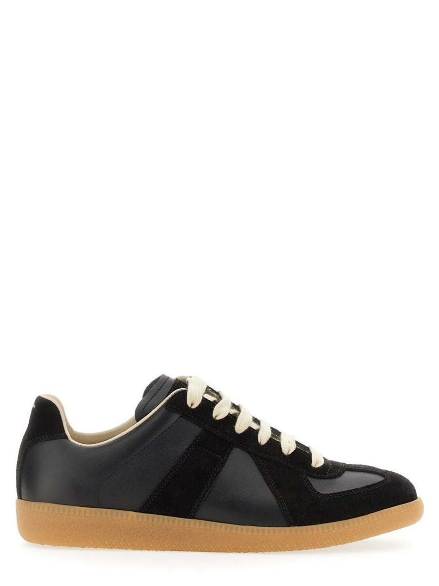 Leather sneakers with stitching detail.webp