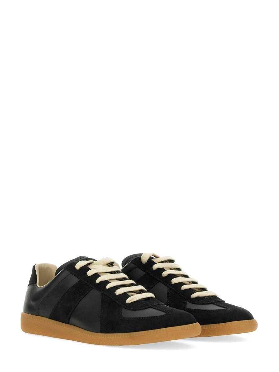 Leather sneakers with stitching detail.webp