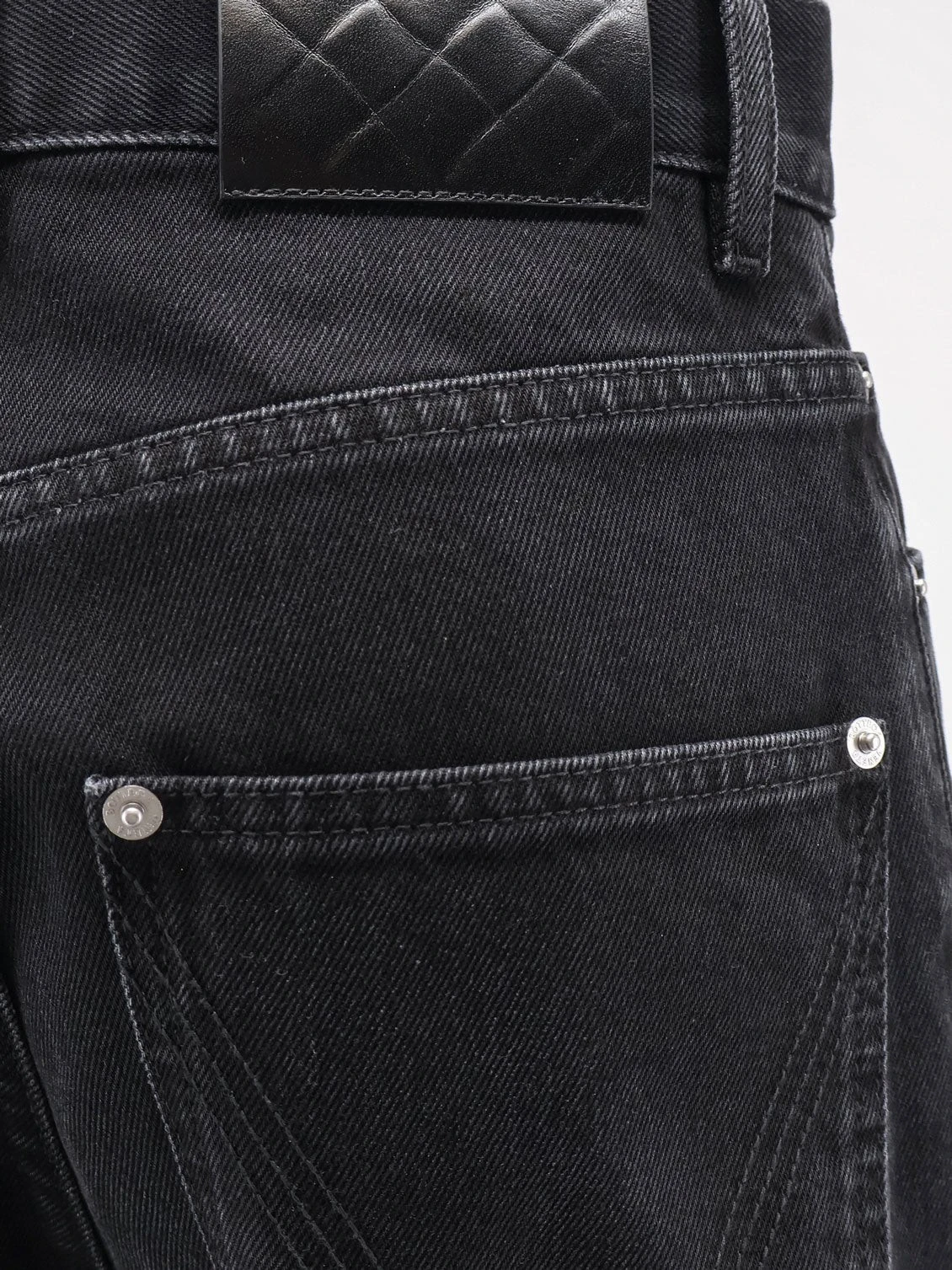 Black denim trousers.webp