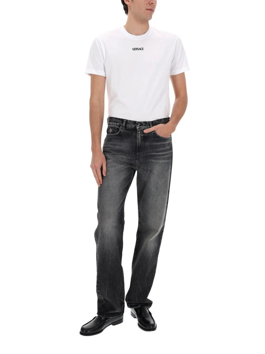JEANS WITH "MEDUSA" DETAIL.webp