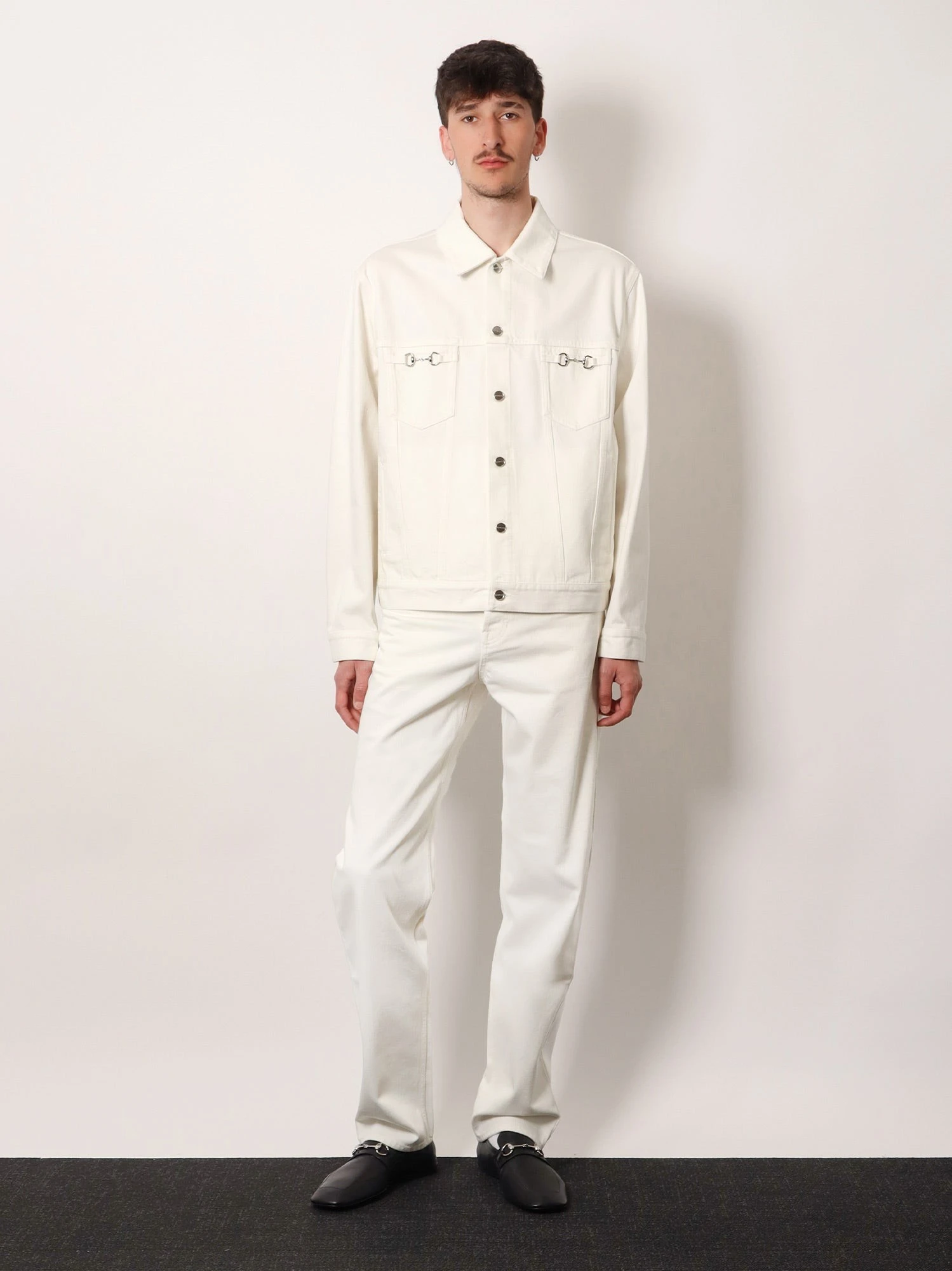 Denim trousers with metal Horsebit detail on the back.webp