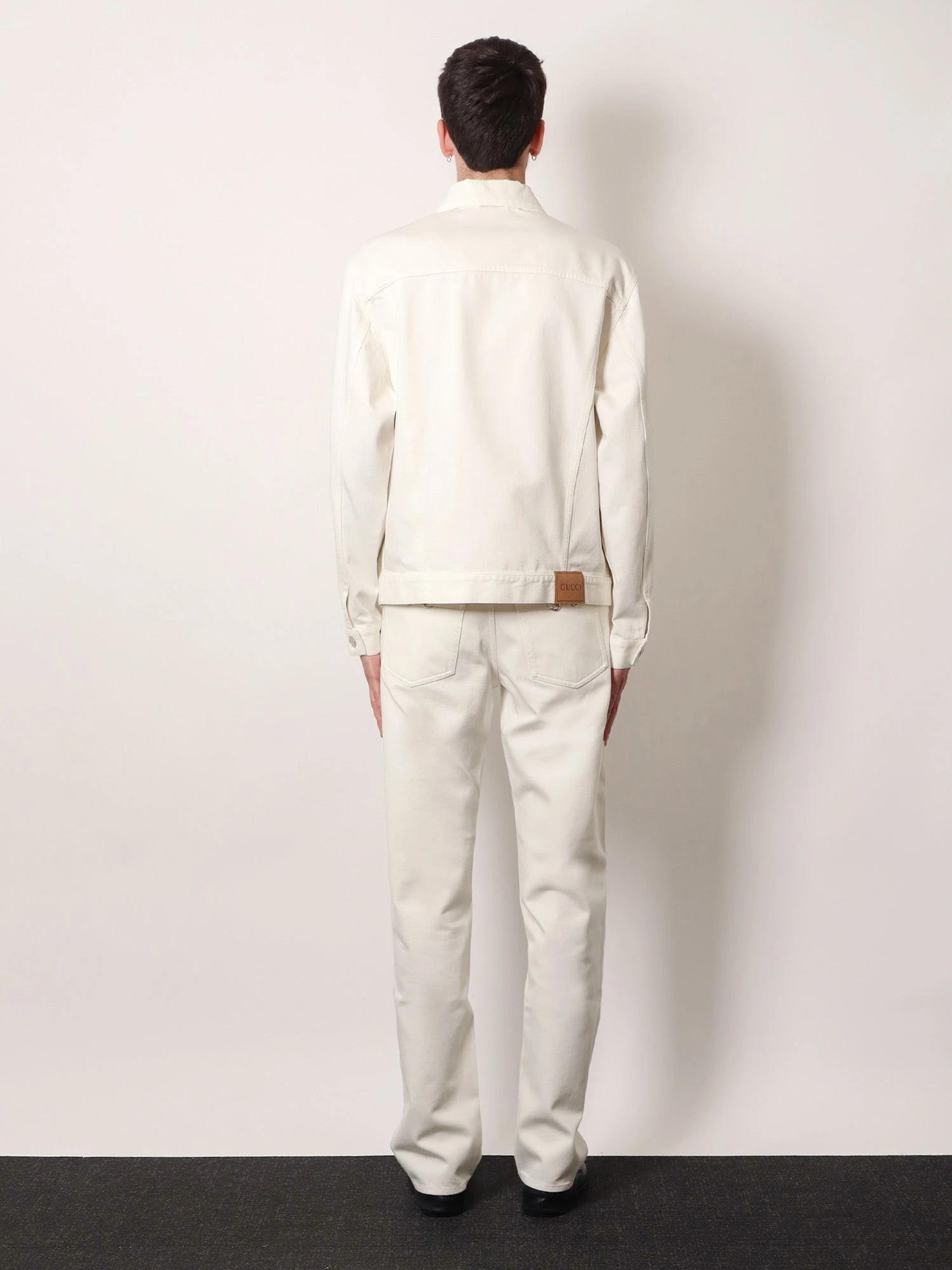 Denim trousers with metal Horsebit detail on the back.webp