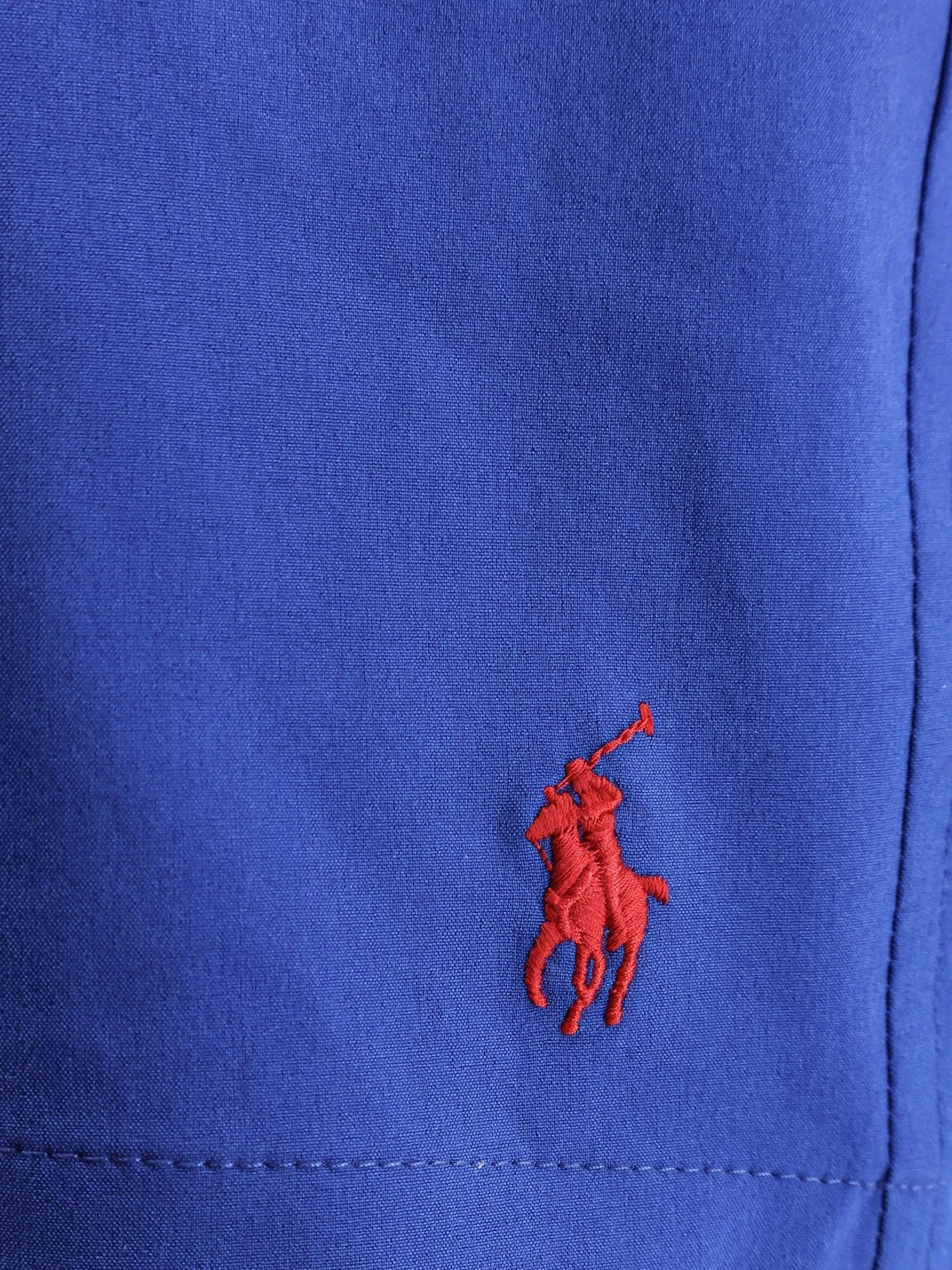 Recycled nylon swim trunks with embroidered logo on the front.webp