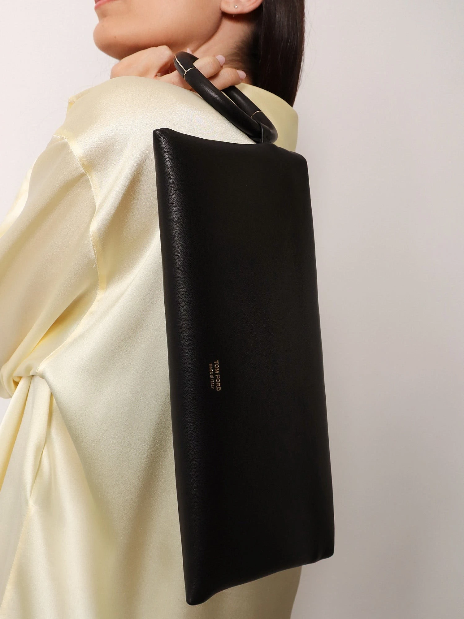 Aura leather clutch bag with lettering logo on the front.webp