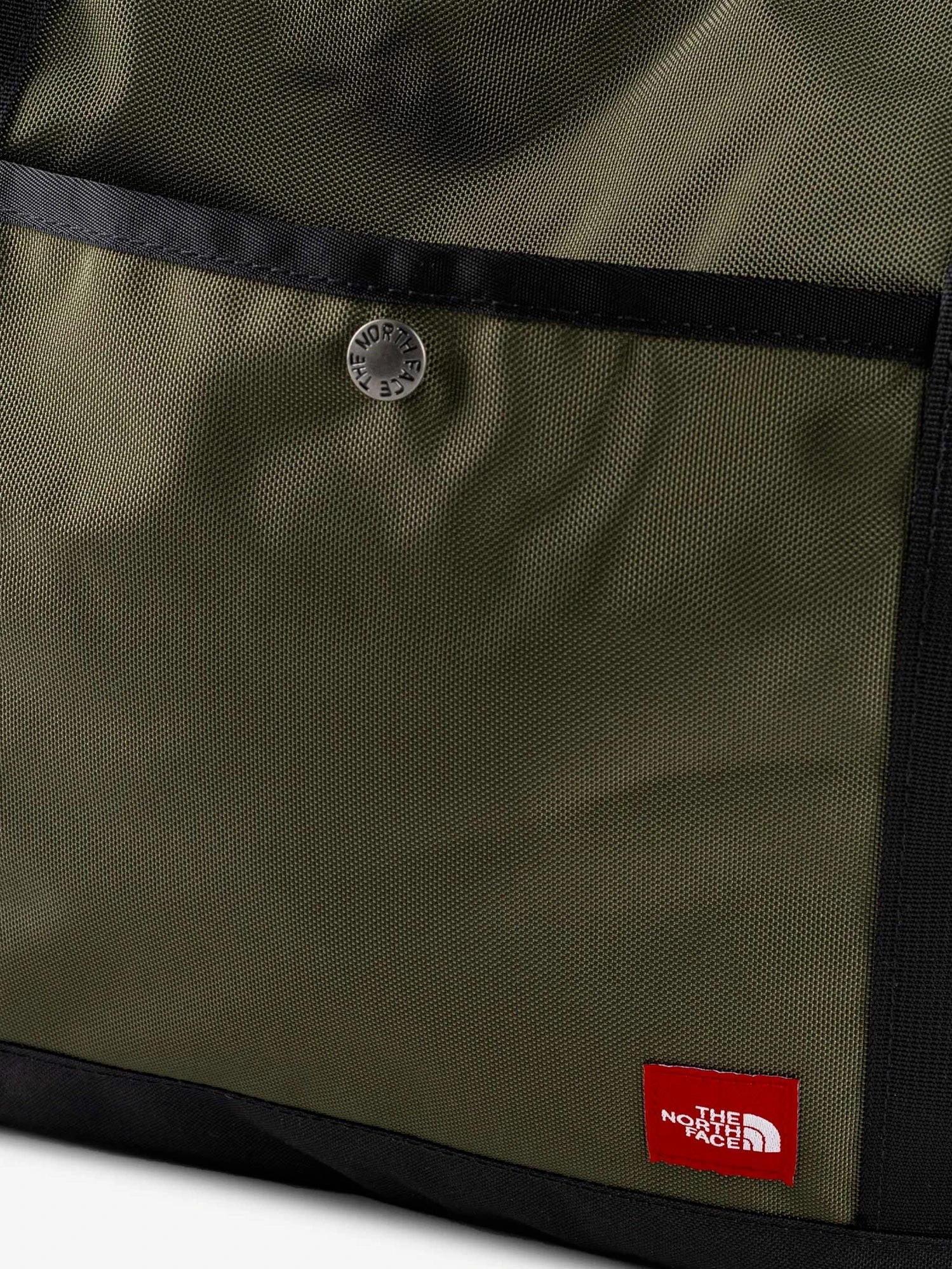 Nylon shoulder bag with logo label on the bottom.webp