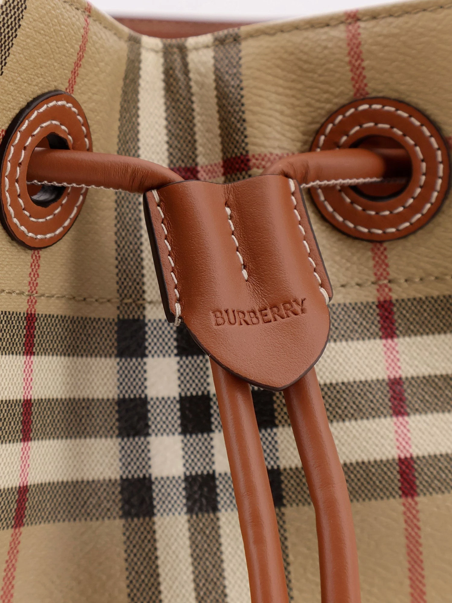 Coated canvas bucket bag with check pattern.webp