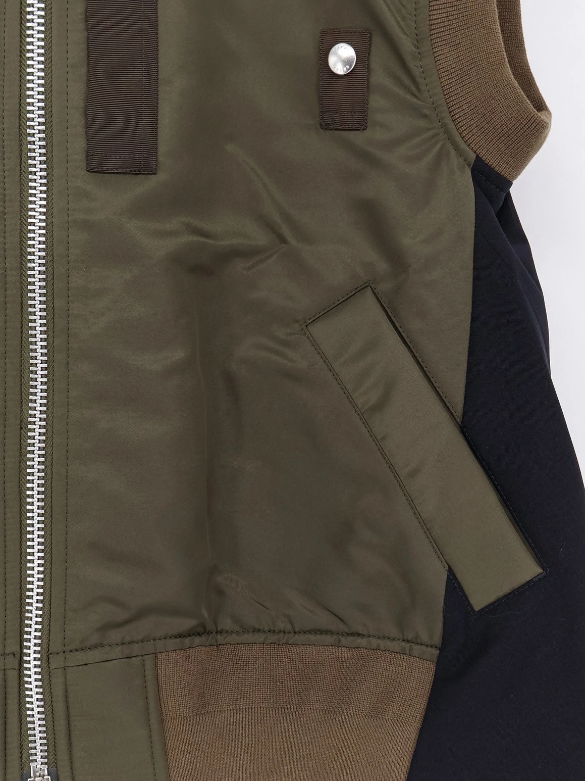 Nylon jacket with fabric insert on the back.webp
