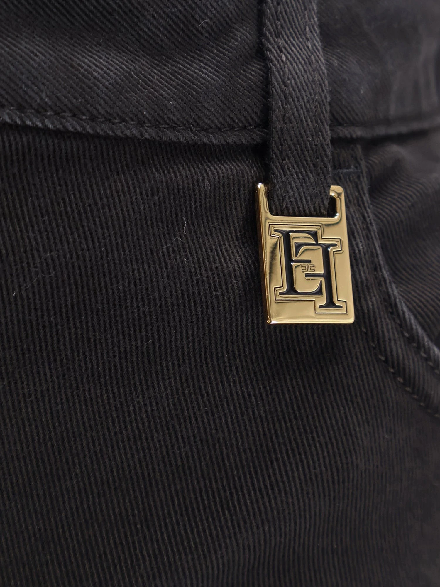 Black denim trousers.webp