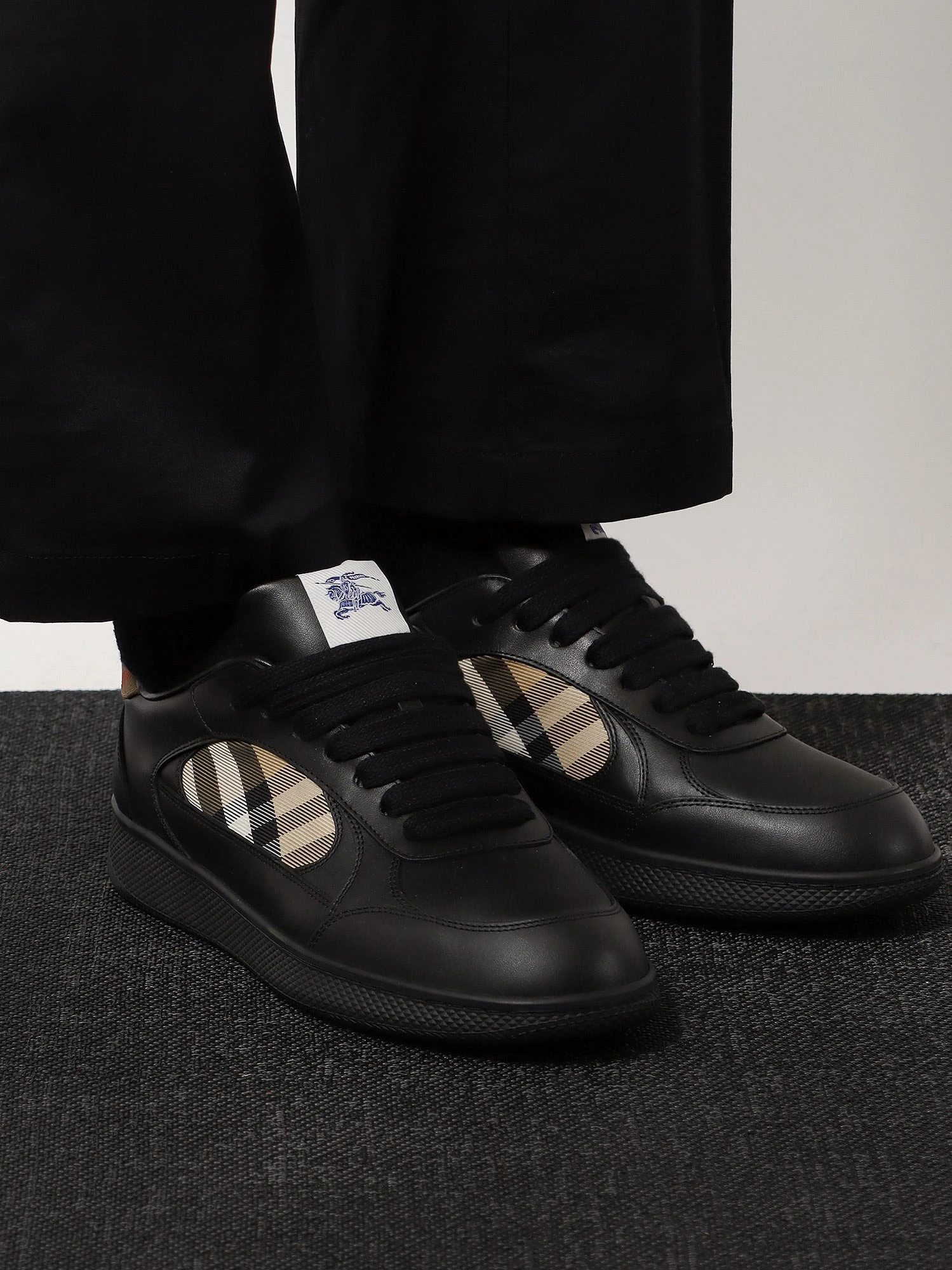 Leather sneakers with Traditional Check inserts.webp