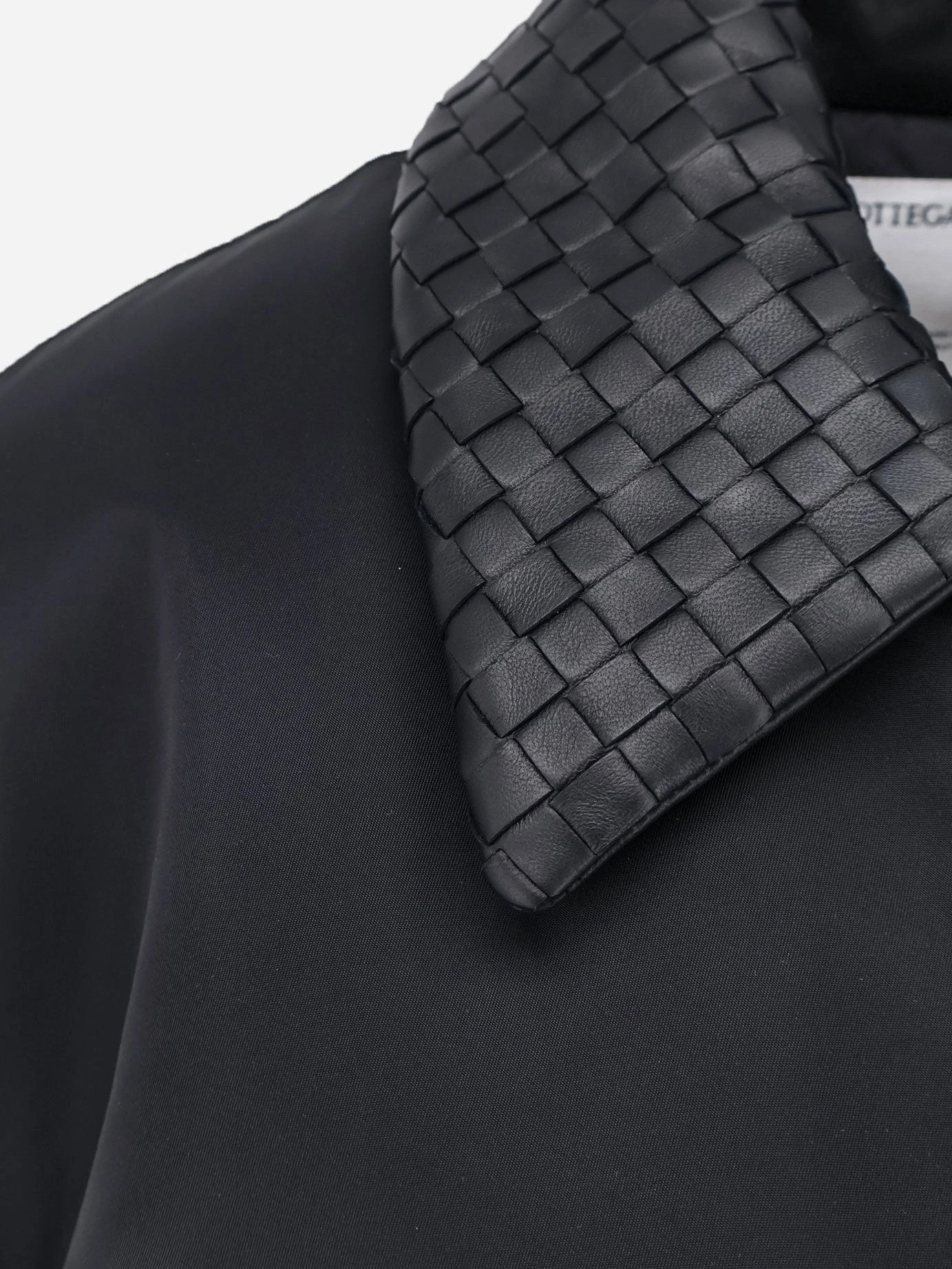 Nylon jacket with Intrecciato leather collar.webp