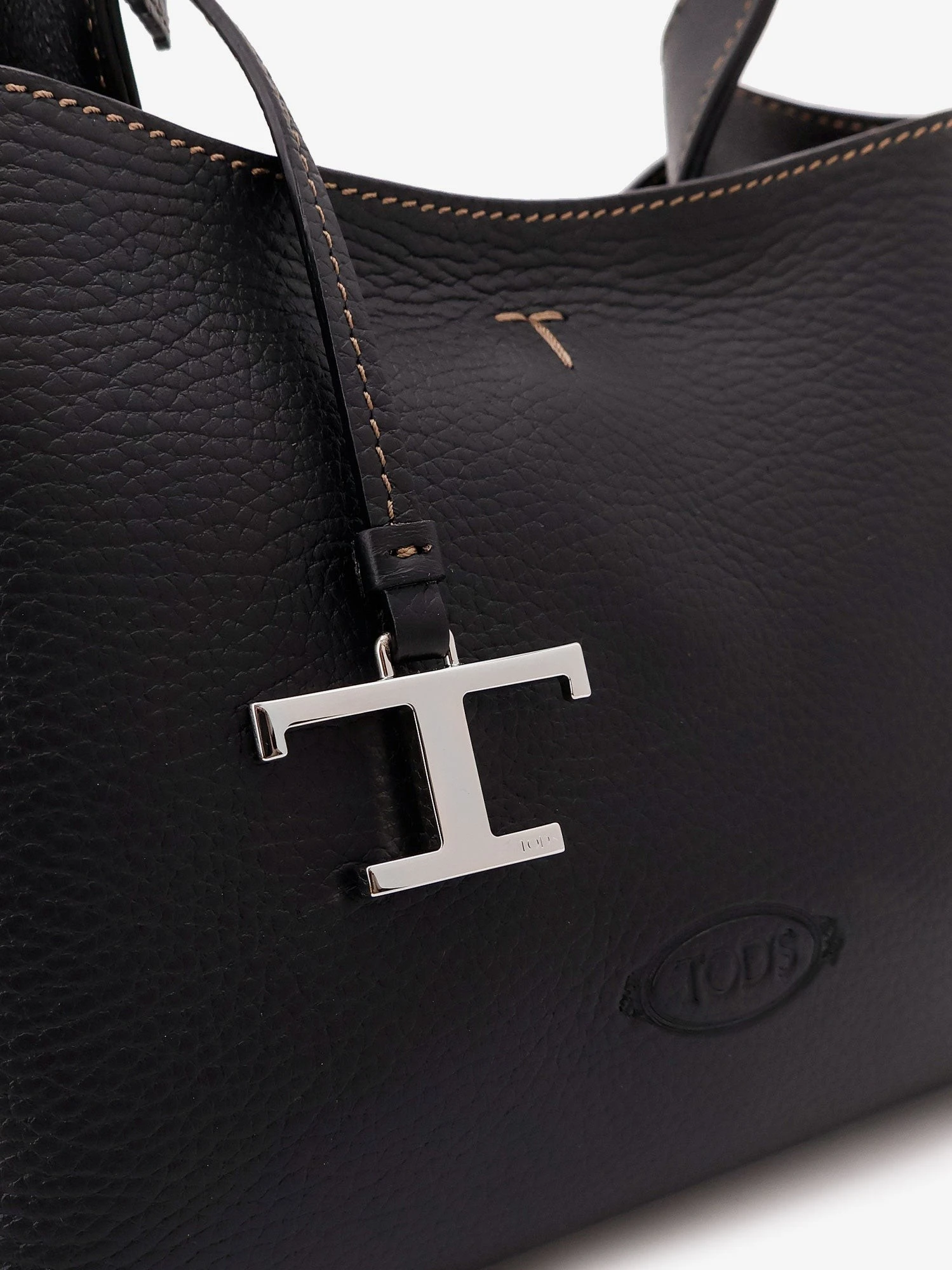 Micro leather crossbody bag with iconic stitching on the front.webp