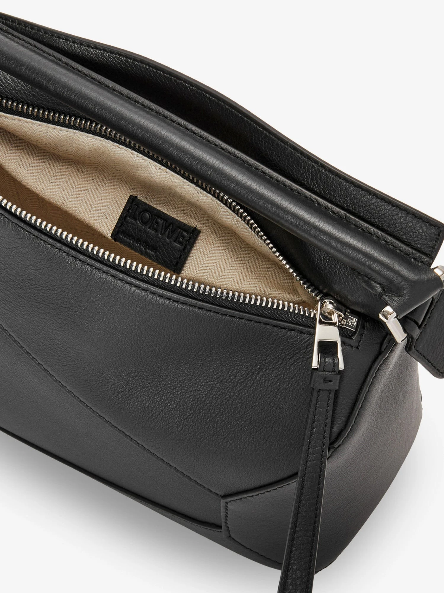 Puzzle Edge leather handbag with engraved Anagram logo.webp