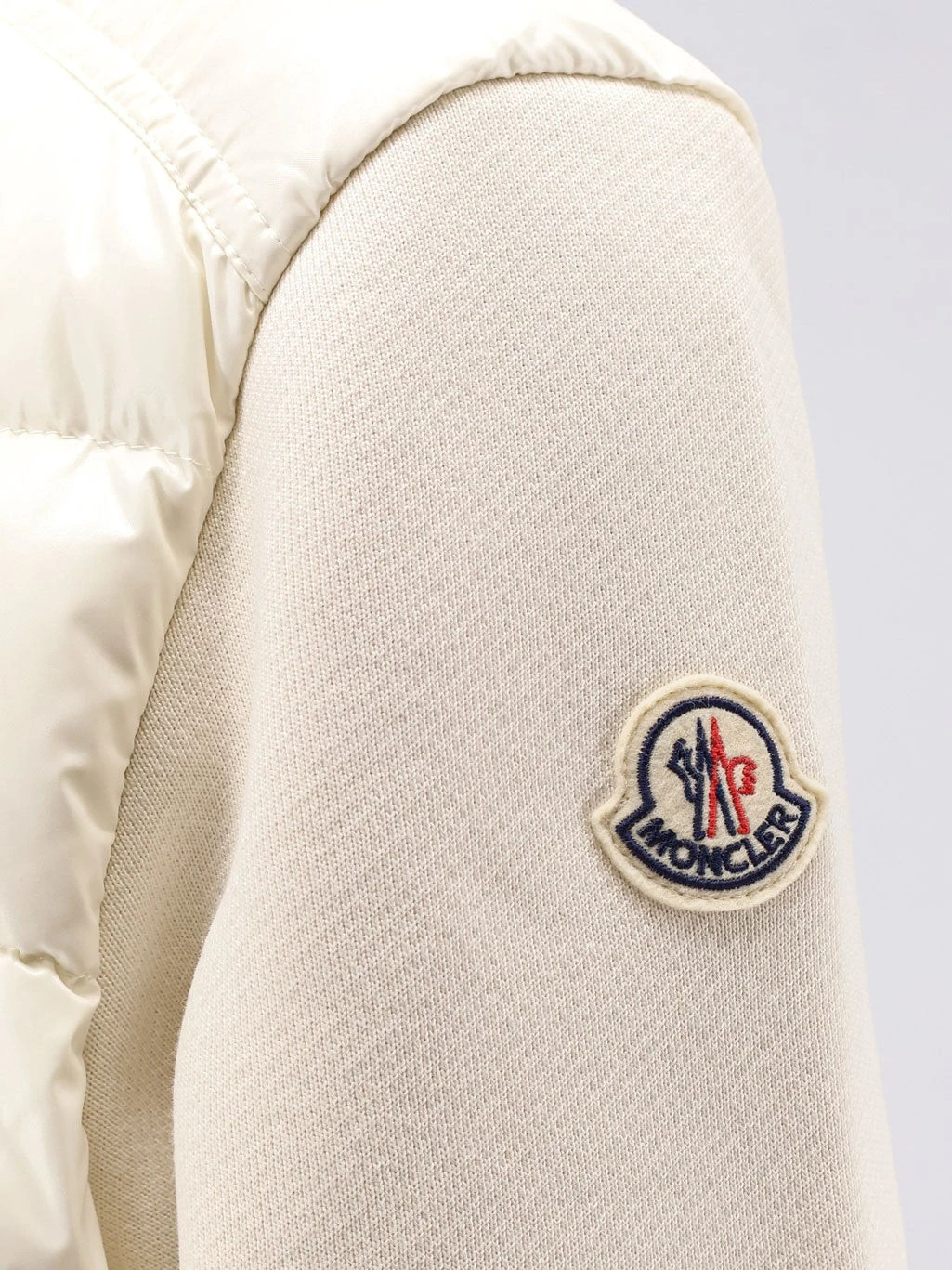 Padded jacket with fabric details.webp