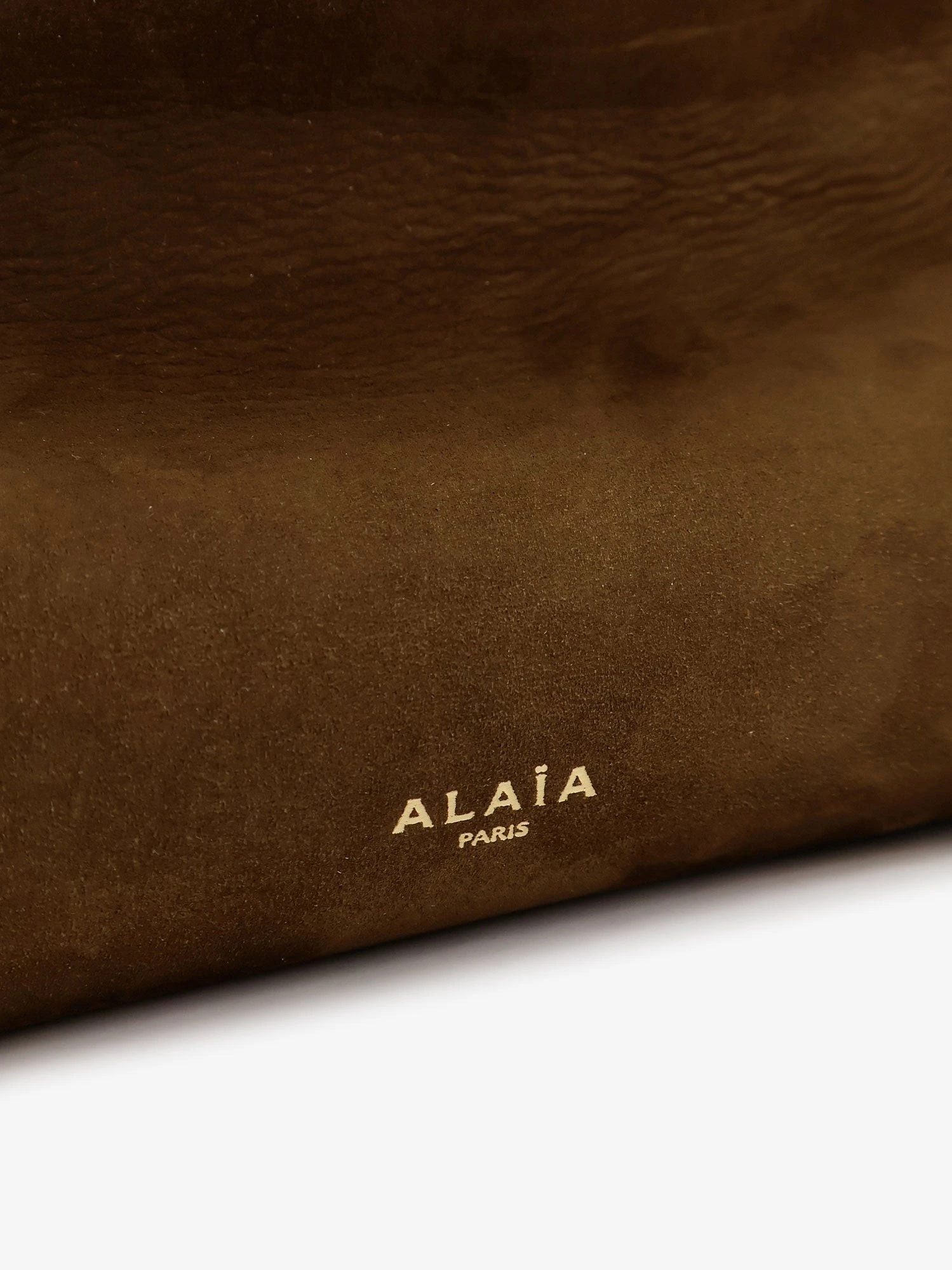 East West leather shoulder bag with engraved logo lettering.webp